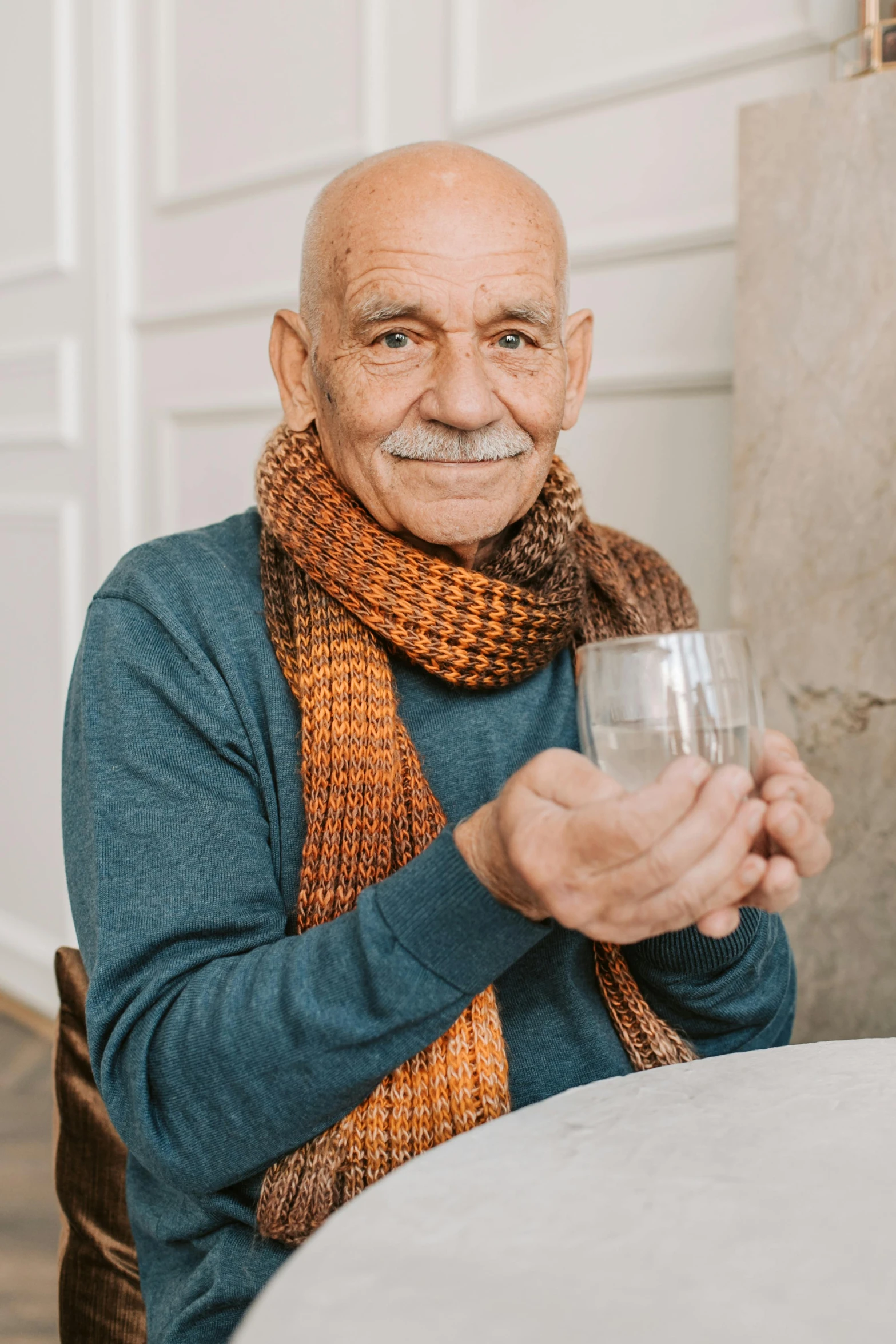 the old man is holding up his glass