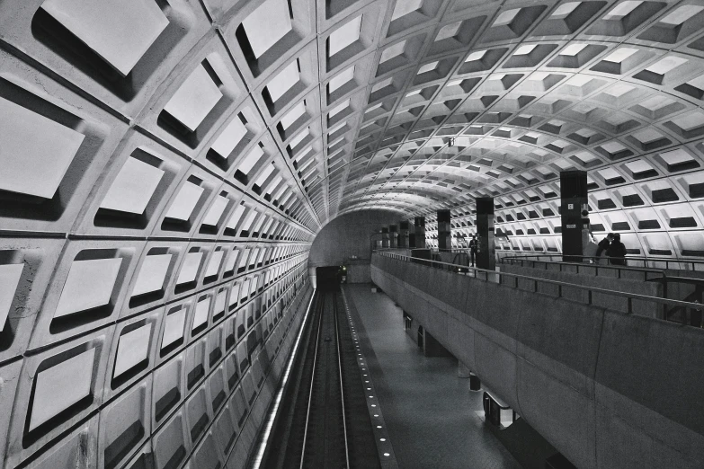 people are walking in an underground subway train station