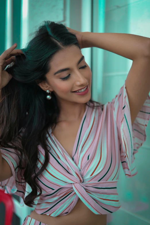 an asian woman wearing pink and black stripes