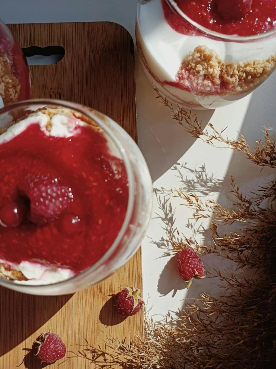 two yogurt dishes with strawberries and oats