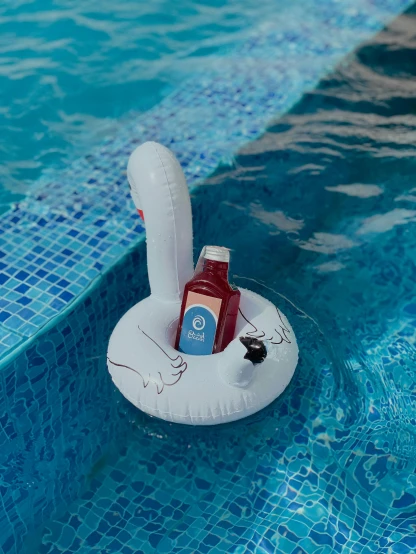 an inflatable air filled swimming float holds a cup of juice