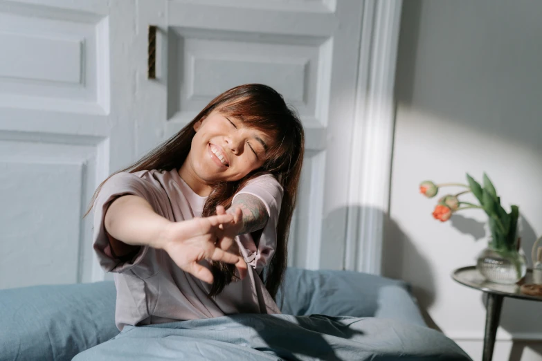 a little girl in gray shirt on blue couch