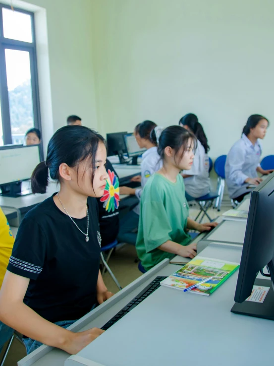 there is people sitting at desks at computers