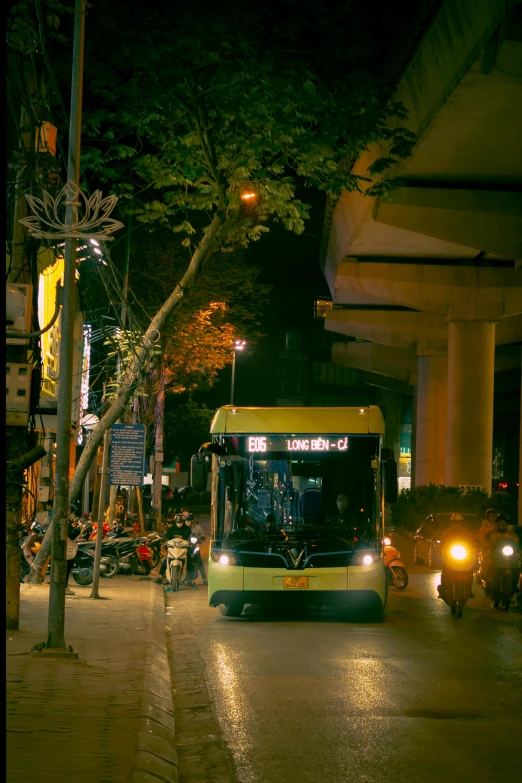 a bus on a street at night with the headlights on