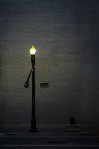 a lamp post next to a building with a yellow light on