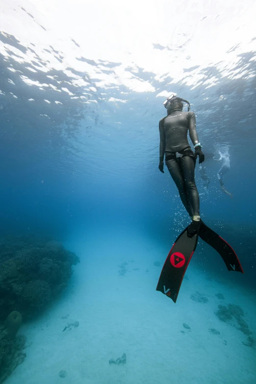 a person with a snork underwater holding a surfboard