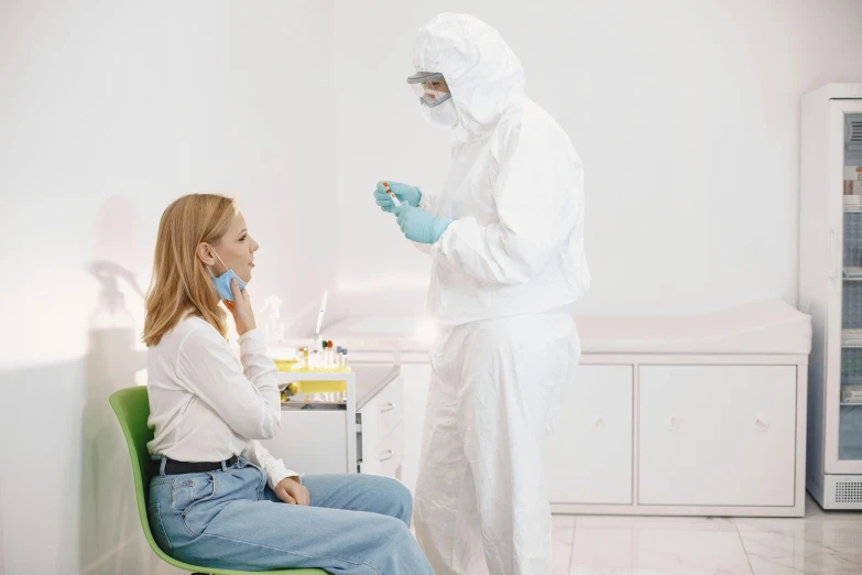 a woman standing in a white lab next to a man