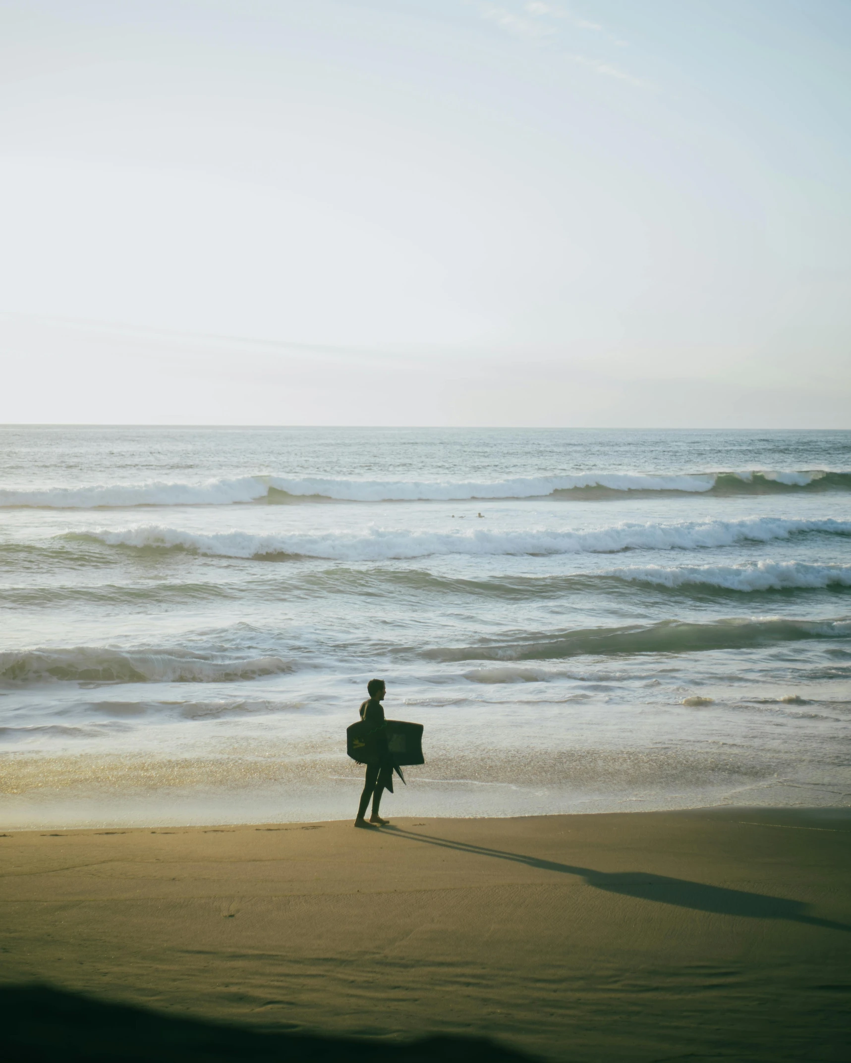 there is a person that is holding a surfboard