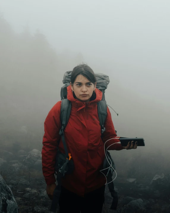 a person with a backpack and water bottle in the fog