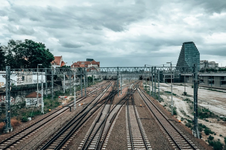 an overcast day at a railway track intersection