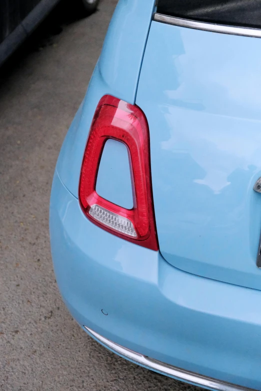 an unusual blue tail light from the back view of a car