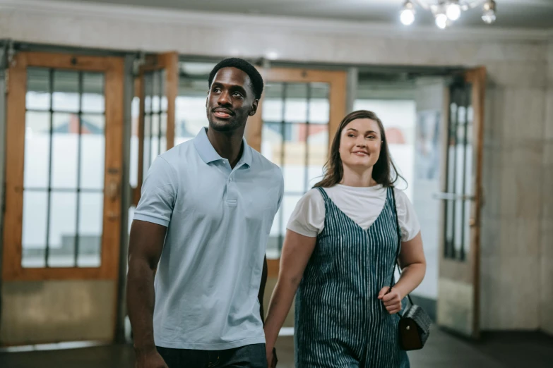 a young woman walking next to a young man