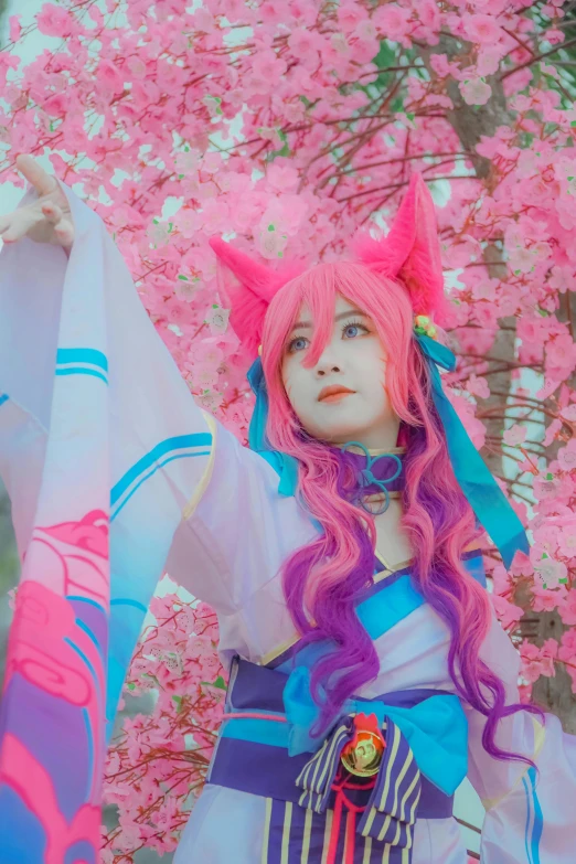 a cosplay with long hair in front of cherry blossoms