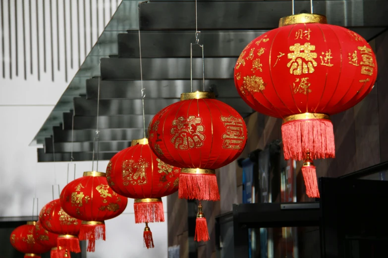 a row of red lanterns with gold foil designs