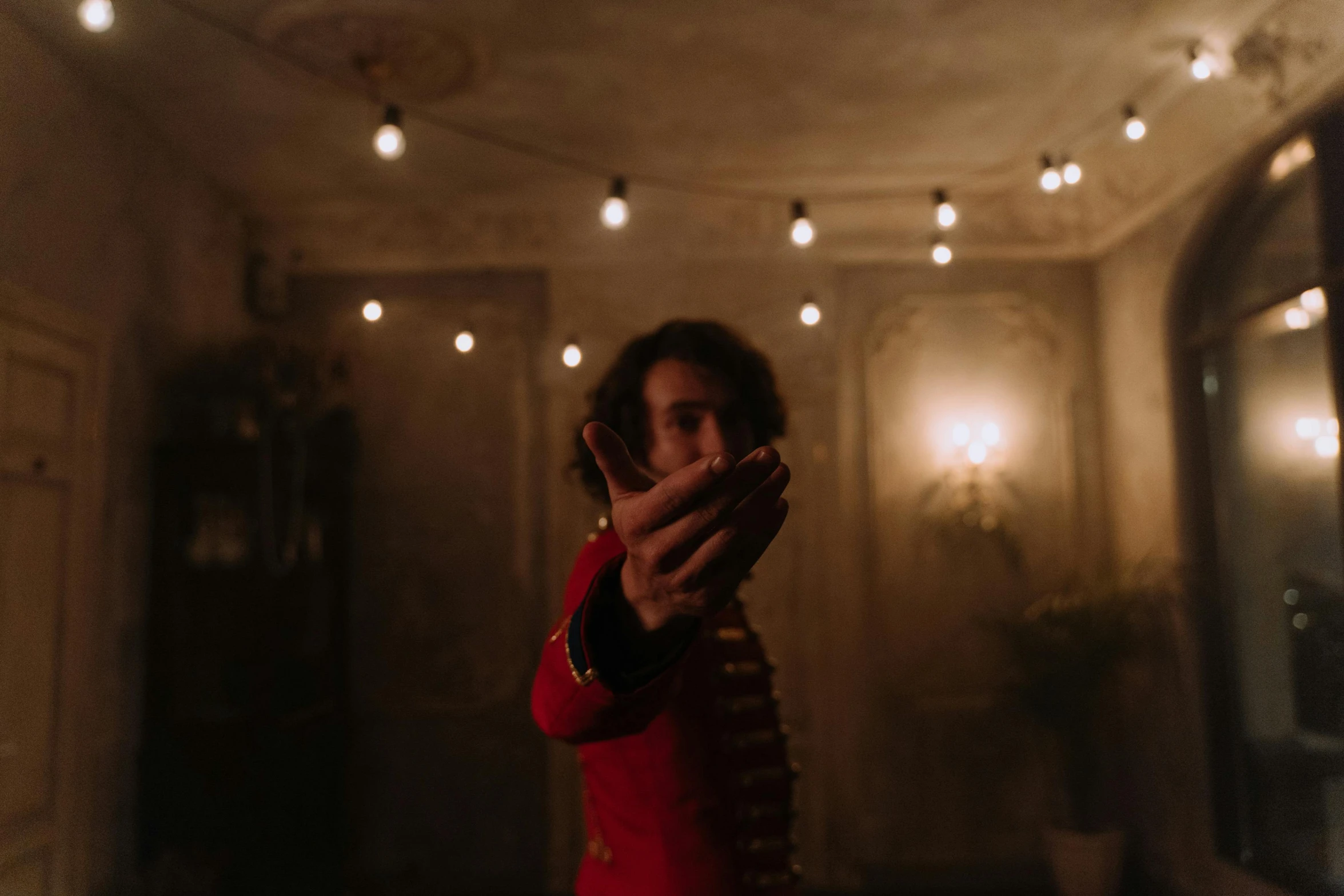 a young man holding a remote in an apartment