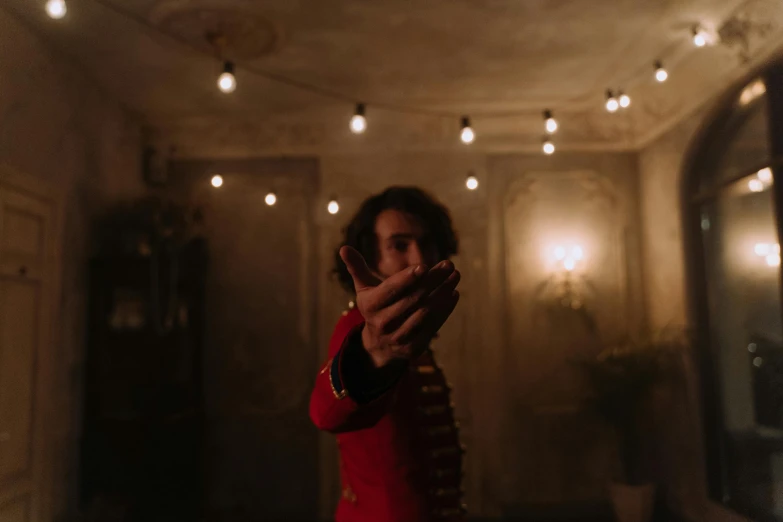 a young man holding a remote in an apartment