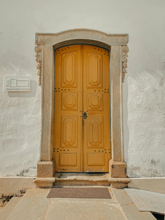 a white building with an open yellow door