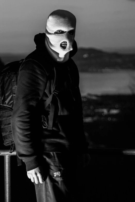 a person standing with his back to the camera with a mask on