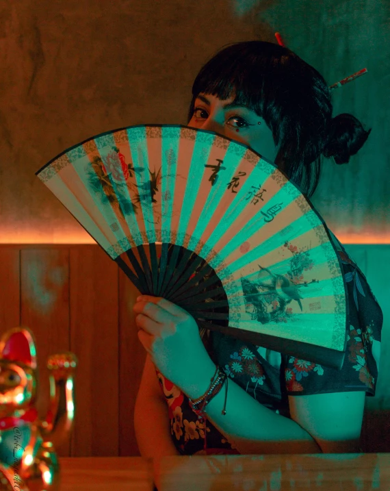 a woman holding an oriental fan in her hand