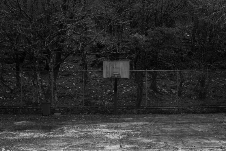 the fence on the tennis court is tall and dark