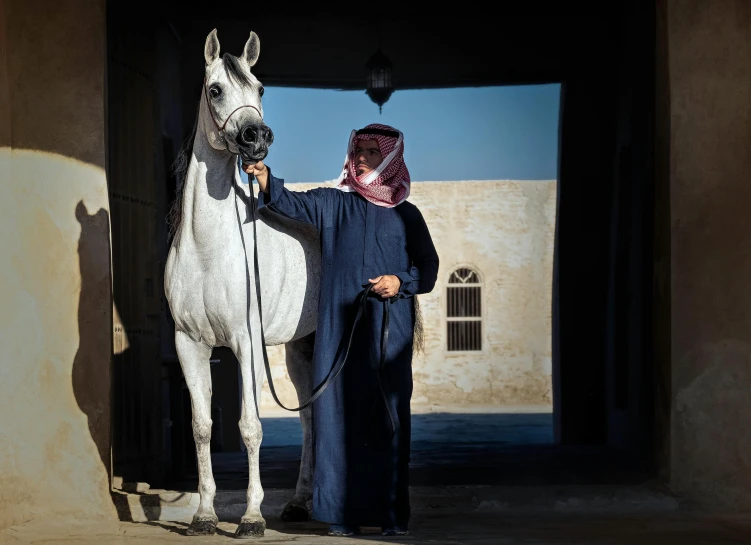 a woman that is standing next to a horse