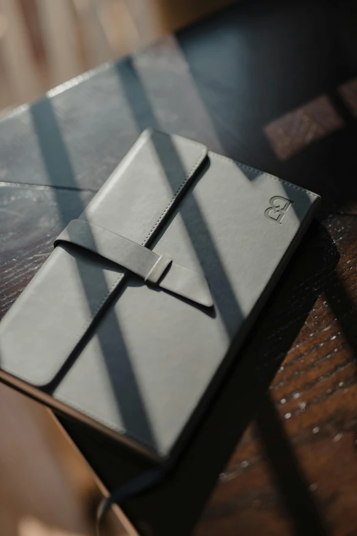 an open notebook is on a wooden table