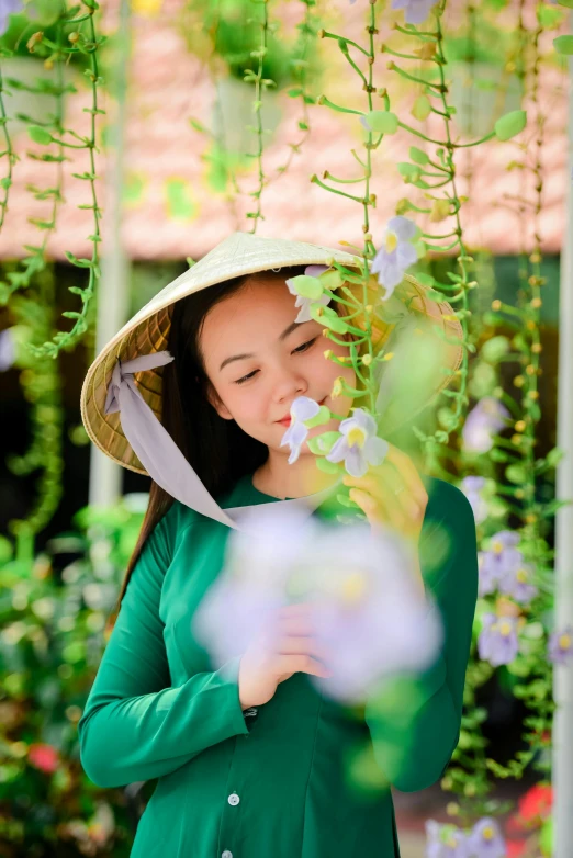 a woman in a green dress and hat