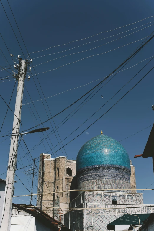 blue dome on blue building in front of large power line