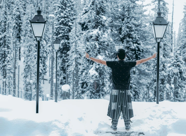 there is a man that is snowboarding on a snowy hill