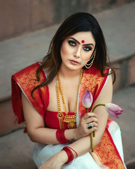 the woman wearing a red outfit is holding flowers