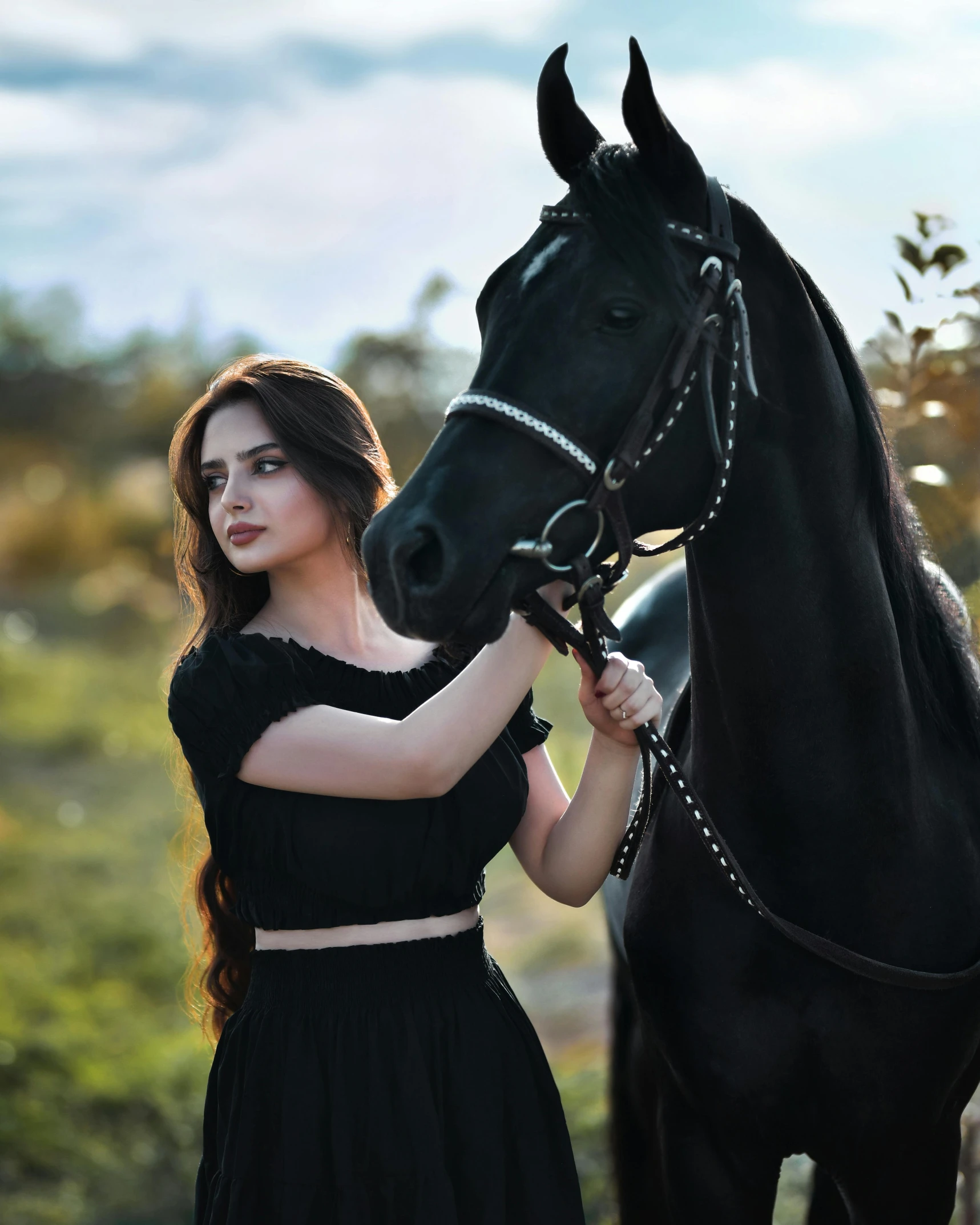 a young woman poses with a horse while holding it