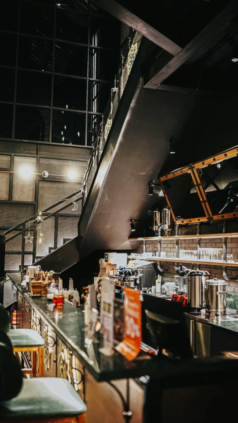 a bar inside of a restaurant with people milling in