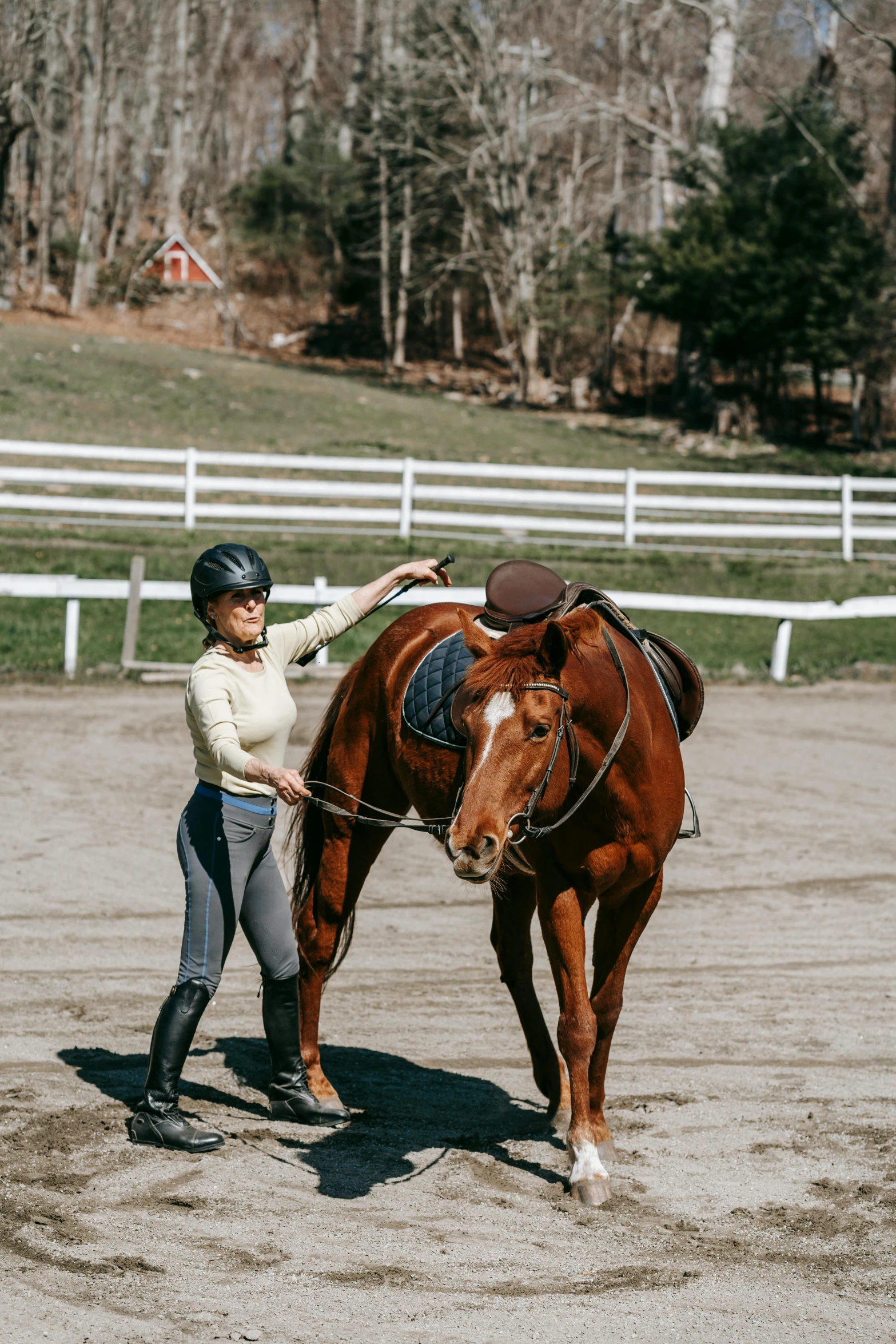 a woman is helping her horse to get around