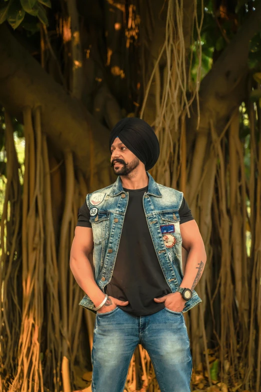 a man stands in front of a banyan tree