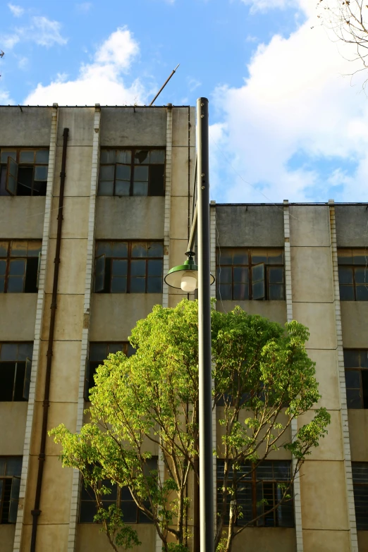 a clock is mounted on the side of a tall building