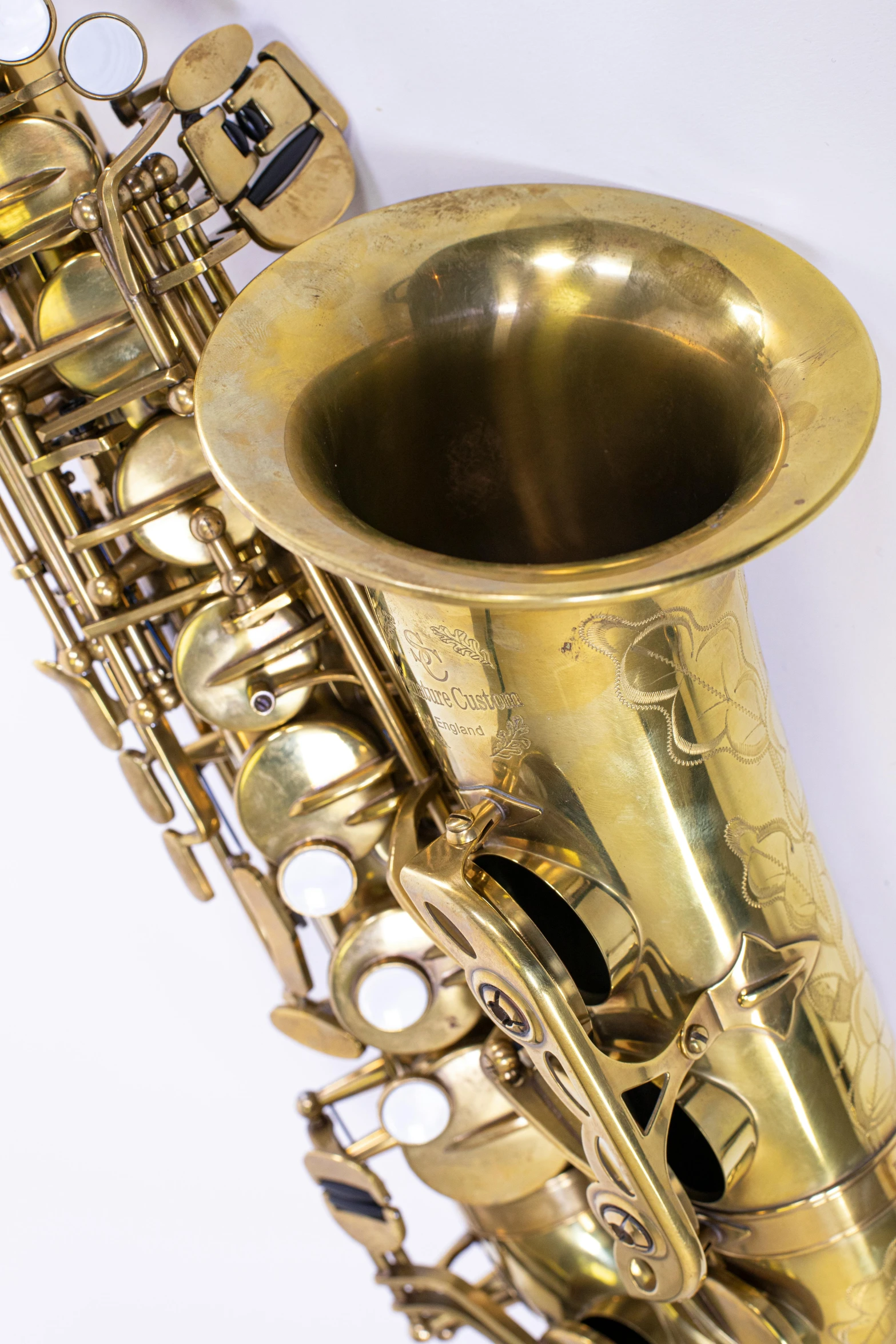 a gold colored saxophone with keys and case