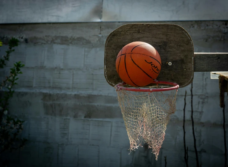 a basketball is thrown from the back of a basket