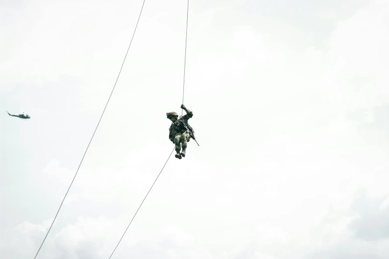 a man is holding on to a wire