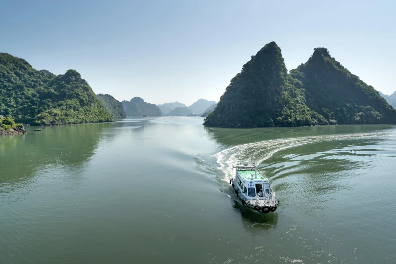 boat traveling down a narrow river between mountains