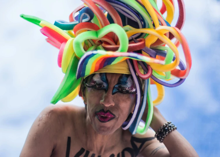 a woman with hair decorated like ribbons has colorful hair