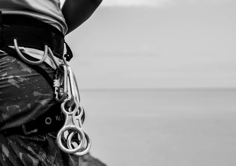 a man standing at the beach wearing chains