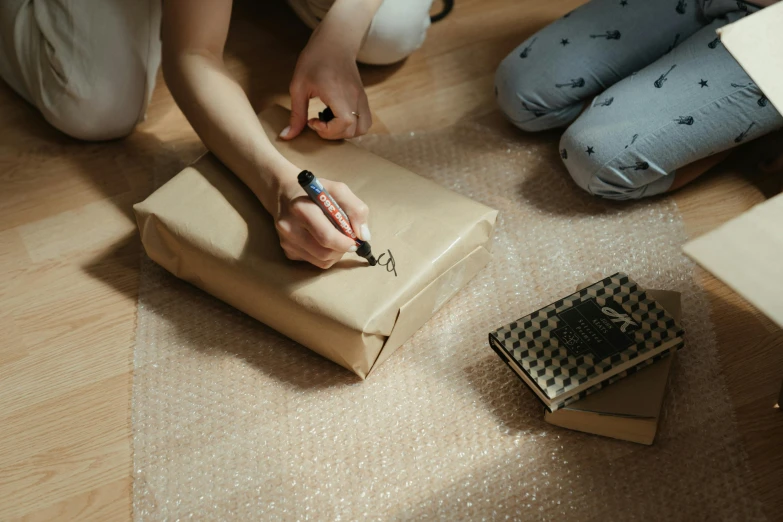 the woman is wrapping a gift with a knife