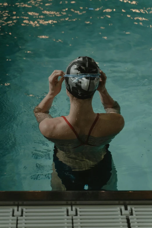 a man taking a picture from above of the water