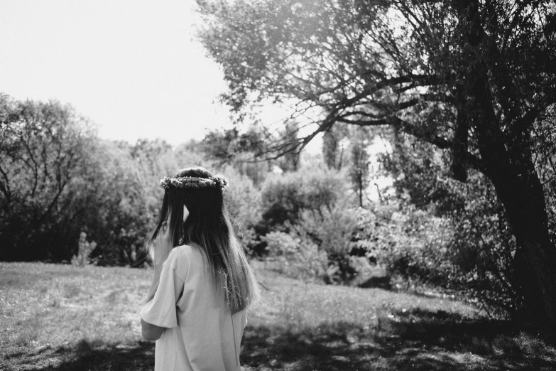 a little girl that is standing in the grass