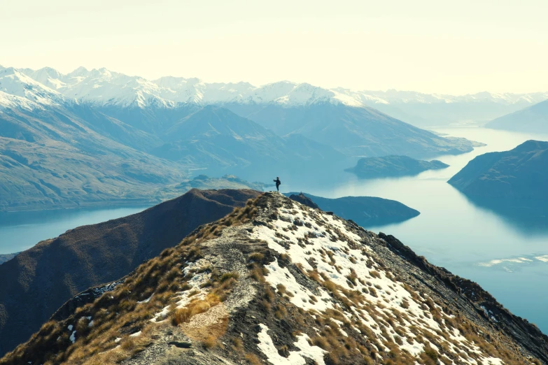 a person on the top of a snowy mountain