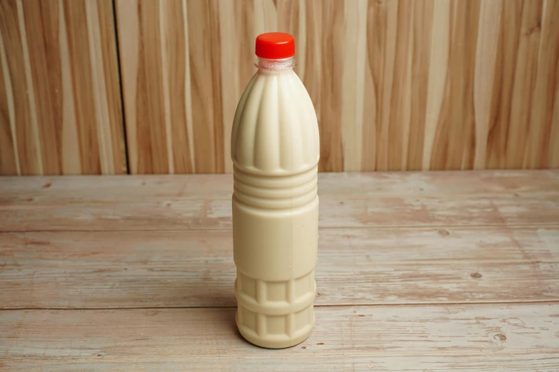 a bottle that is filled with milk on the table