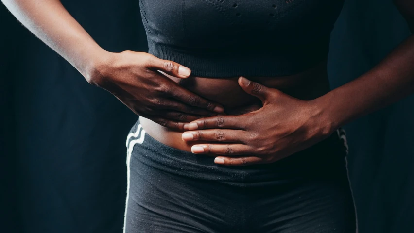 a woman holding her belly to show how much she feels