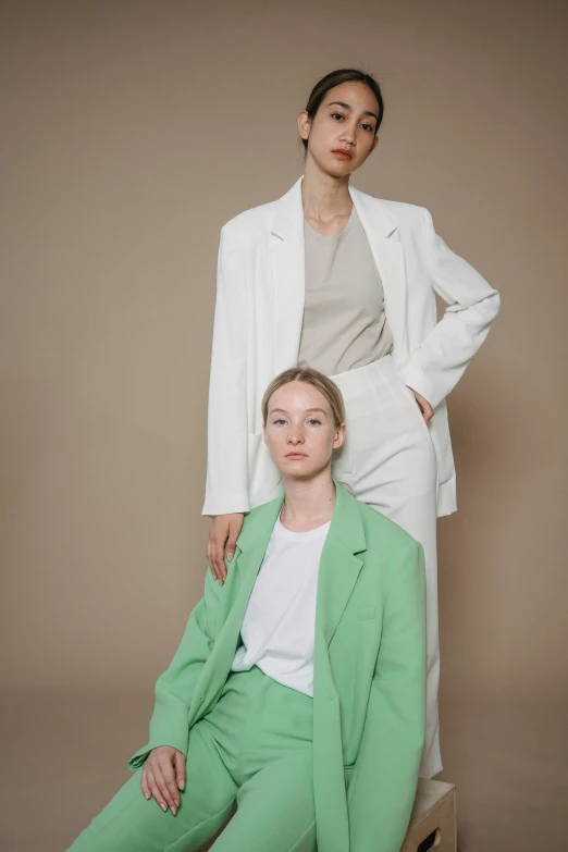 two women in green pants and a white jacket