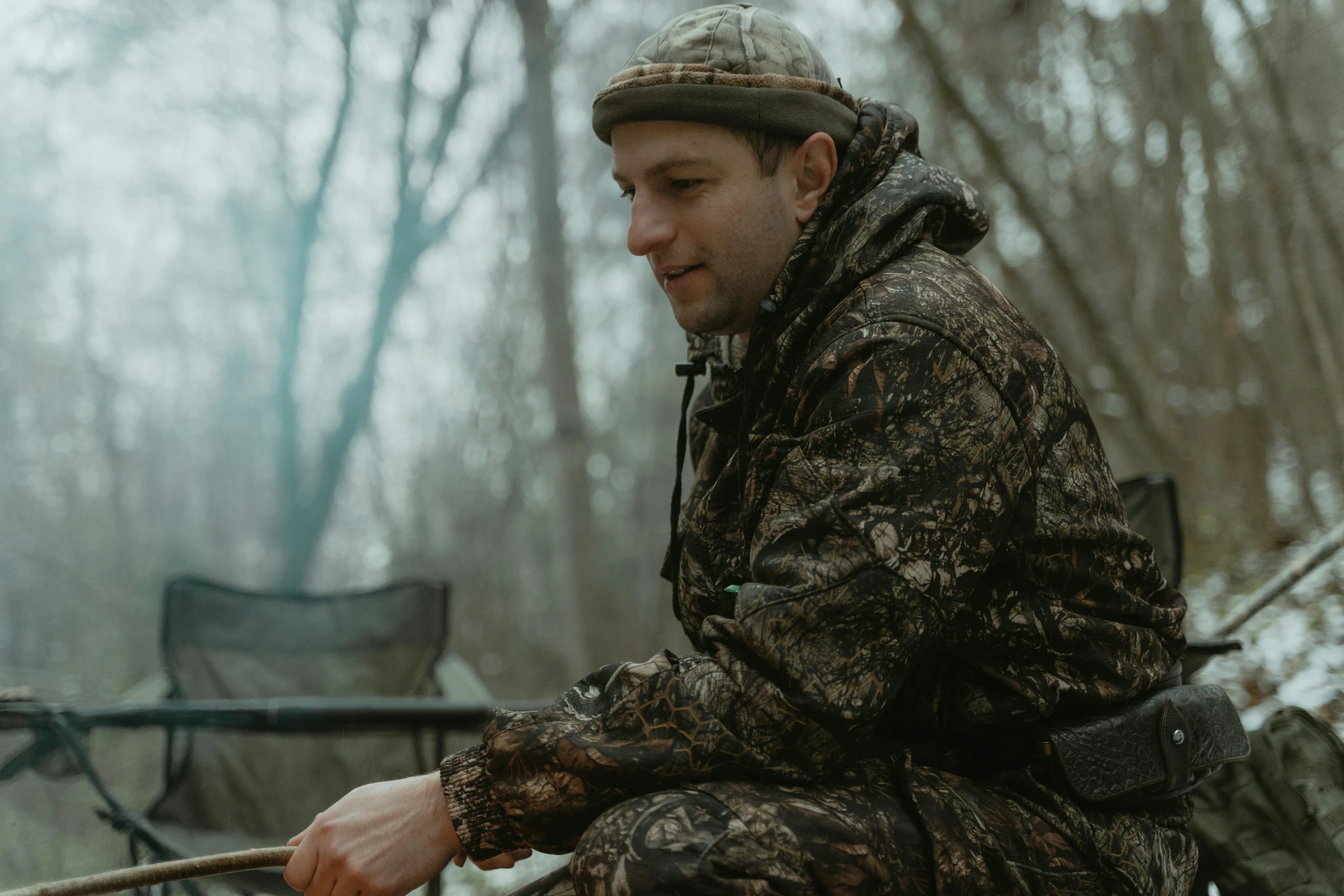 a man cooking on an outdoor fire pit