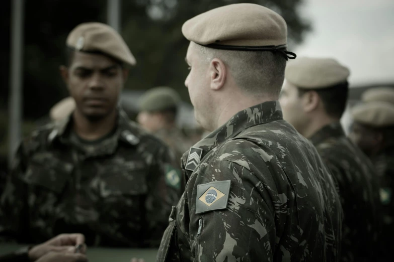 men in uniform are talking in a group